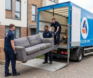 We Clear Junk team loading sofa onto man and van removal truck in London
