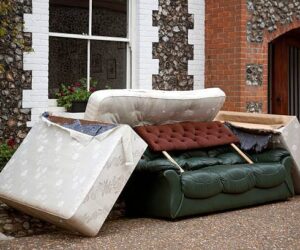 A pile of discarded furniture in a street.
